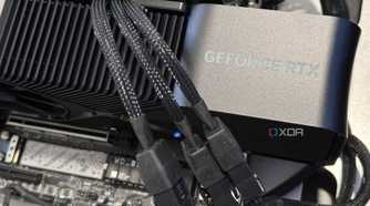nvidia geforce rtx 4080 super graphics card installed in a motherboard showing three power cables going into its power adapter