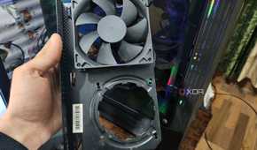 A person holding an NZXT Kraken G12 in front of a PC