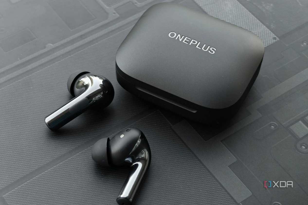 An image showing a pair of OnePlus Buds 3 earbuds sitting next to its charging case.