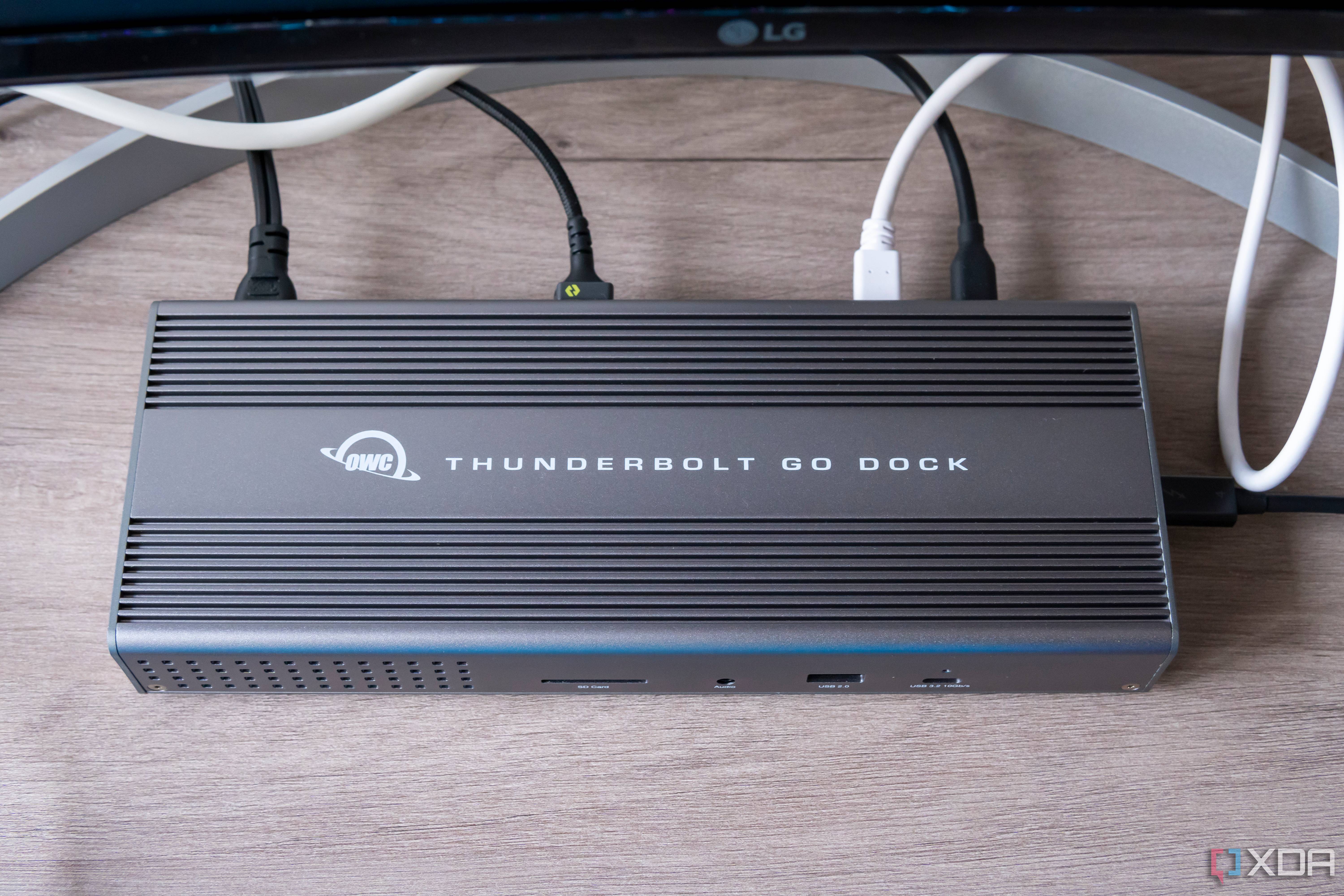 Overhead front view of the OWC Thunderbolt Go Dock with multiple cables plugged into the back