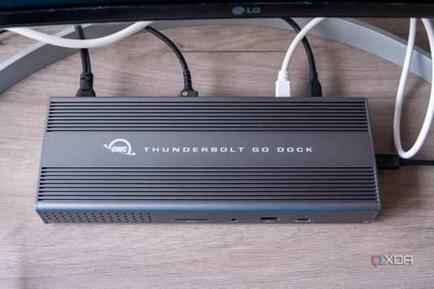 Overhead front view of the OWC Thunderbolt Go Dock with multiple cables plugged into the back