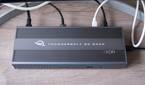 Overhead front view of the OWC Thunderbolt Go Dock with multiple cables plugged into the back