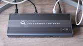Overhead front view of the OWC Thunderbolt Go Dock with multiple cables plugged into the back