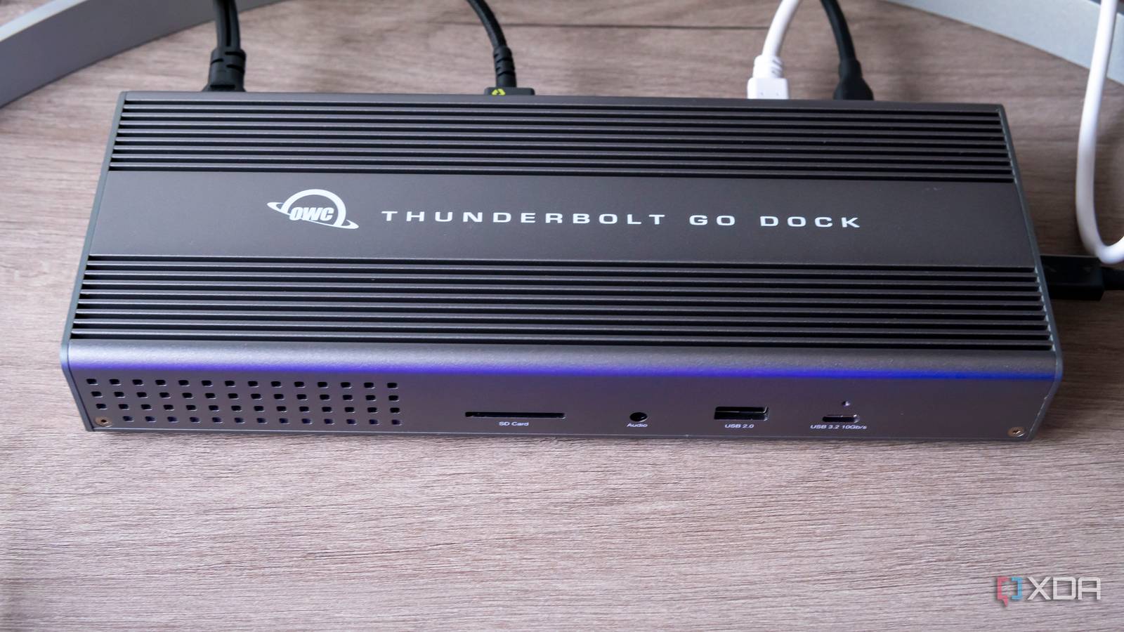 Overhead front view of the OWC Thunderbolt Go Dock with a soft blue light reflecting off of it