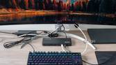 A desk setup with a monitor, keyboard, and laptop, with the Plugable TBT4-UD5 in the center