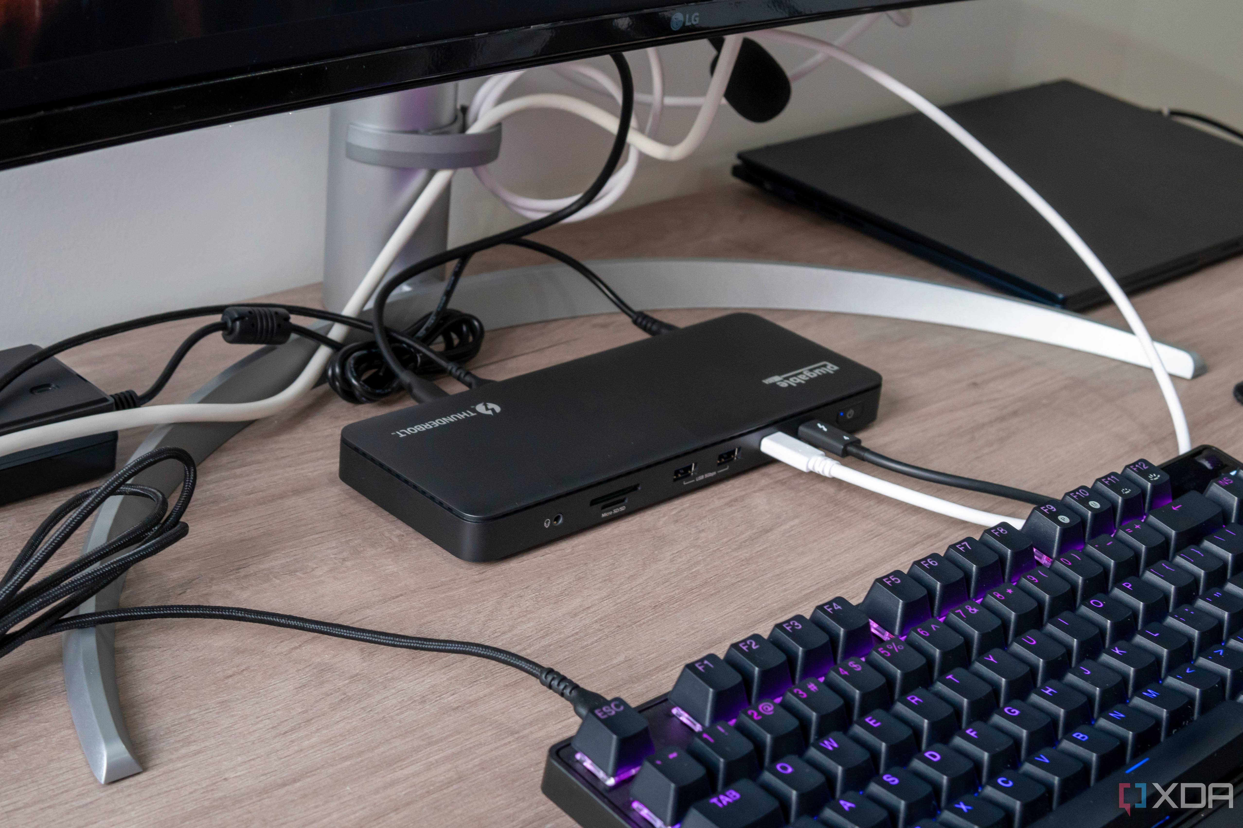 Angled view of the Plugable TBT4-UD5 docking station in a desk setup