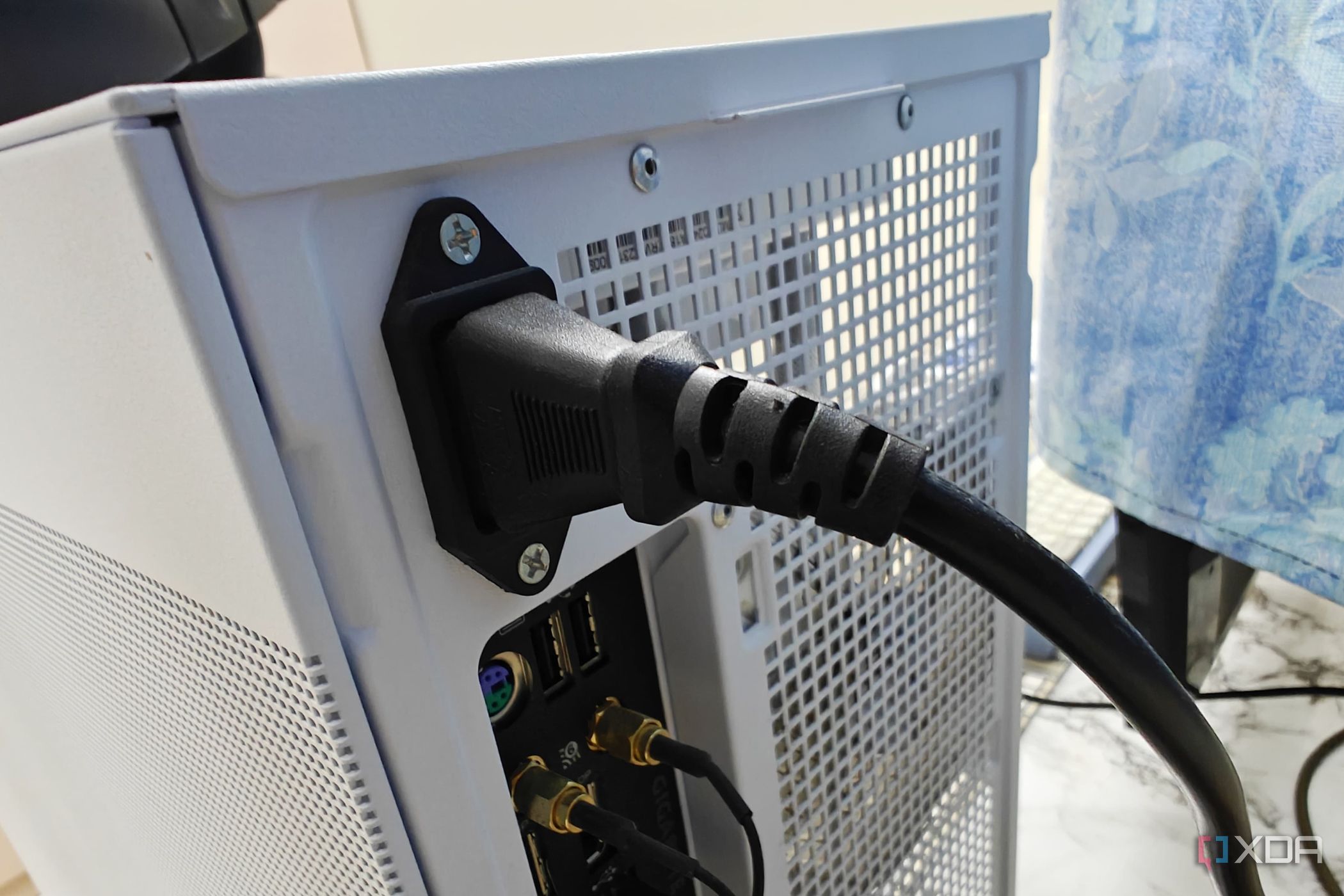 An image showing the power cable connected to the back of the PSU.