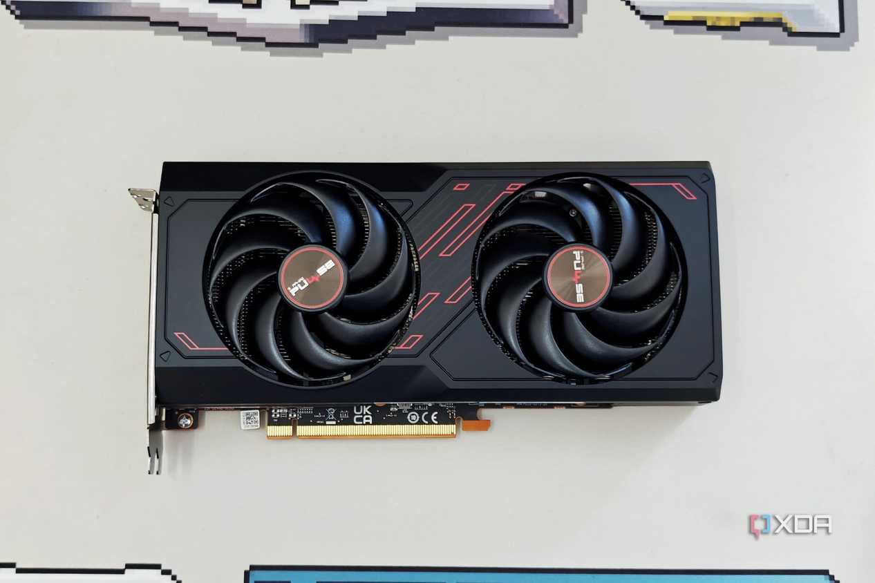An image showing the Sapphire Radeon RX 7600 Pulse OC GPU kept on a beige deskmat.