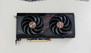 An image showing the Sapphire Radeon RX 7600 Pulse OC GPU kept on a beige deskmat.