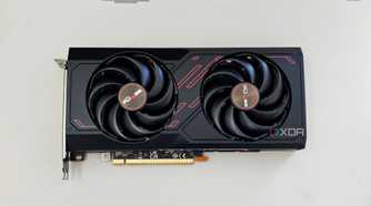 An image showing the Sapphire Radeon RX 7600 Pulse OC GPU kept on a beige deskmat.