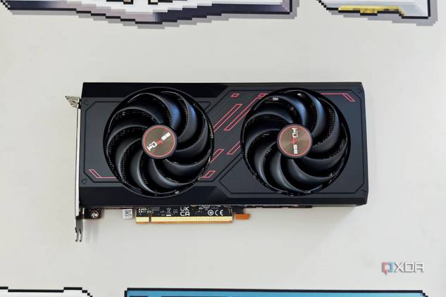 An image showing the Sapphire Radeon RX 7600 Pulse OC GPU kept on a beige deskmat.