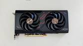An image showing the Sapphire Radeon RX 7600 Pulse OC GPU kept on a beige deskmat.