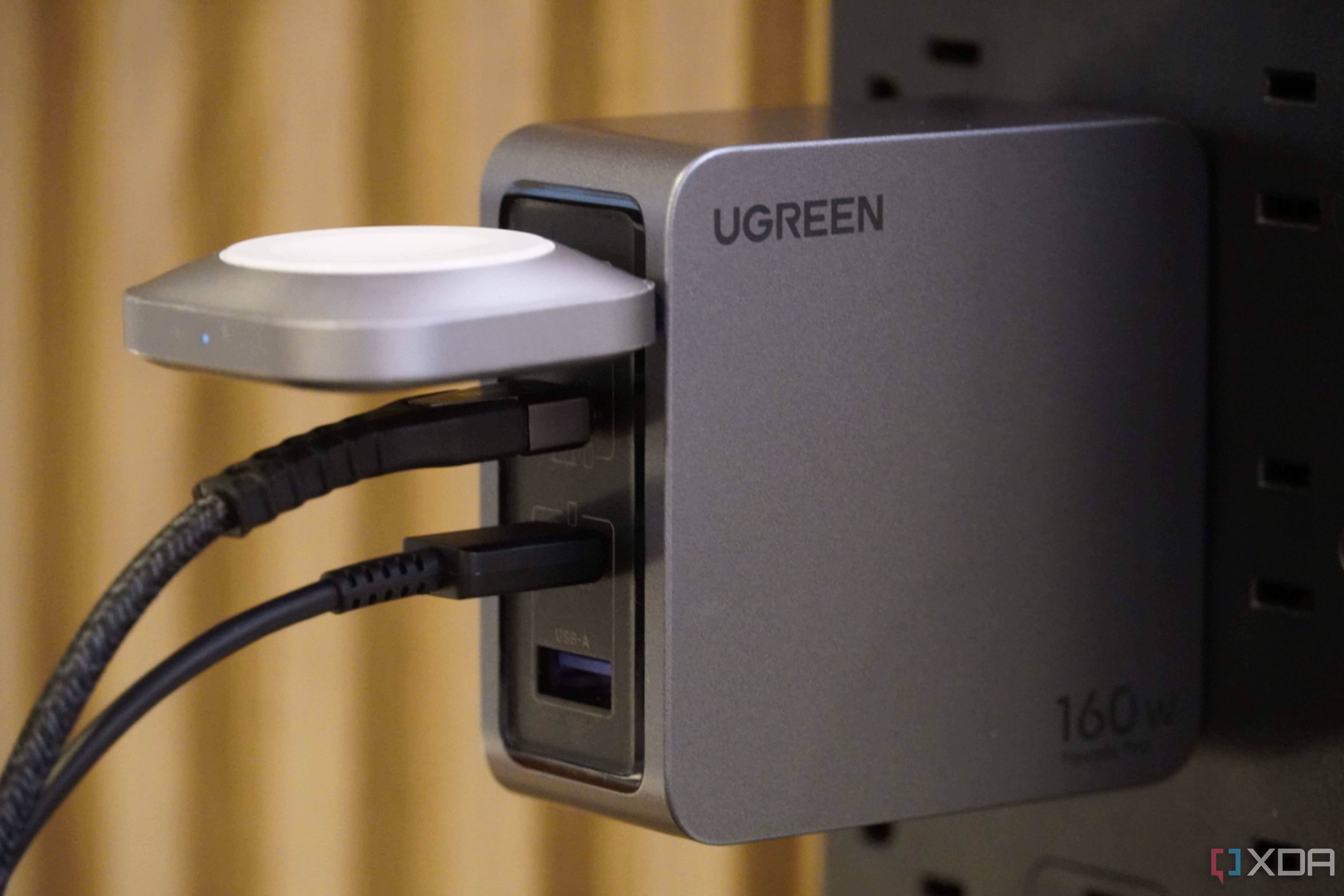 Cables connected to a Ugreen 160W wall charger.