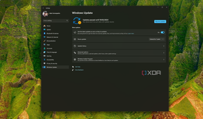 Screenshot of a Windows 11 desktop with the Windows Update page showing updates are paused