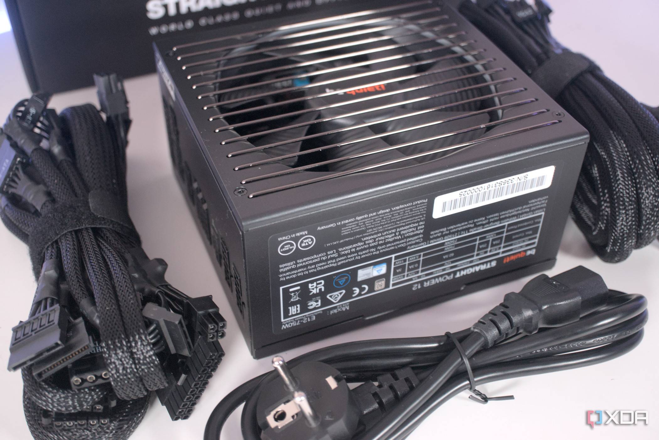 A BeQuiet Pure Power 12M PSU box contents laid out on a white surface