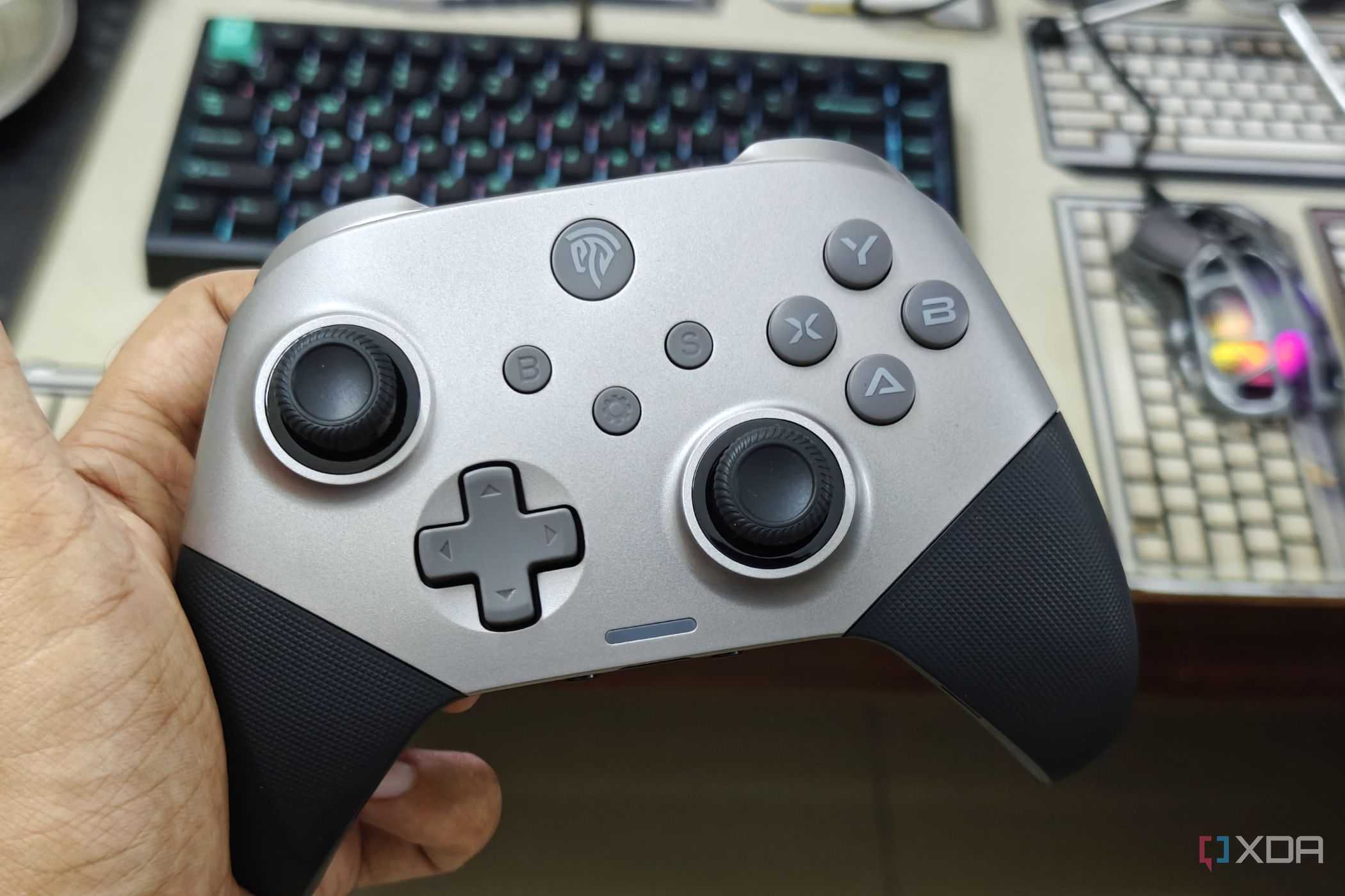 An image showing a person holding the EasySMX controller in their hand.