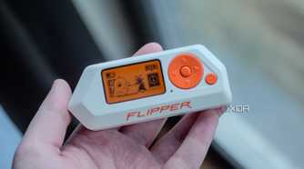 Flipper Zero in ahnd, showing home screen