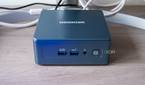Front view of the Geekom Mini IT13 in front of a monitor