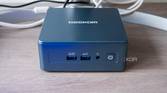 Front view of the Geekom Mini IT13 in front of a monitor