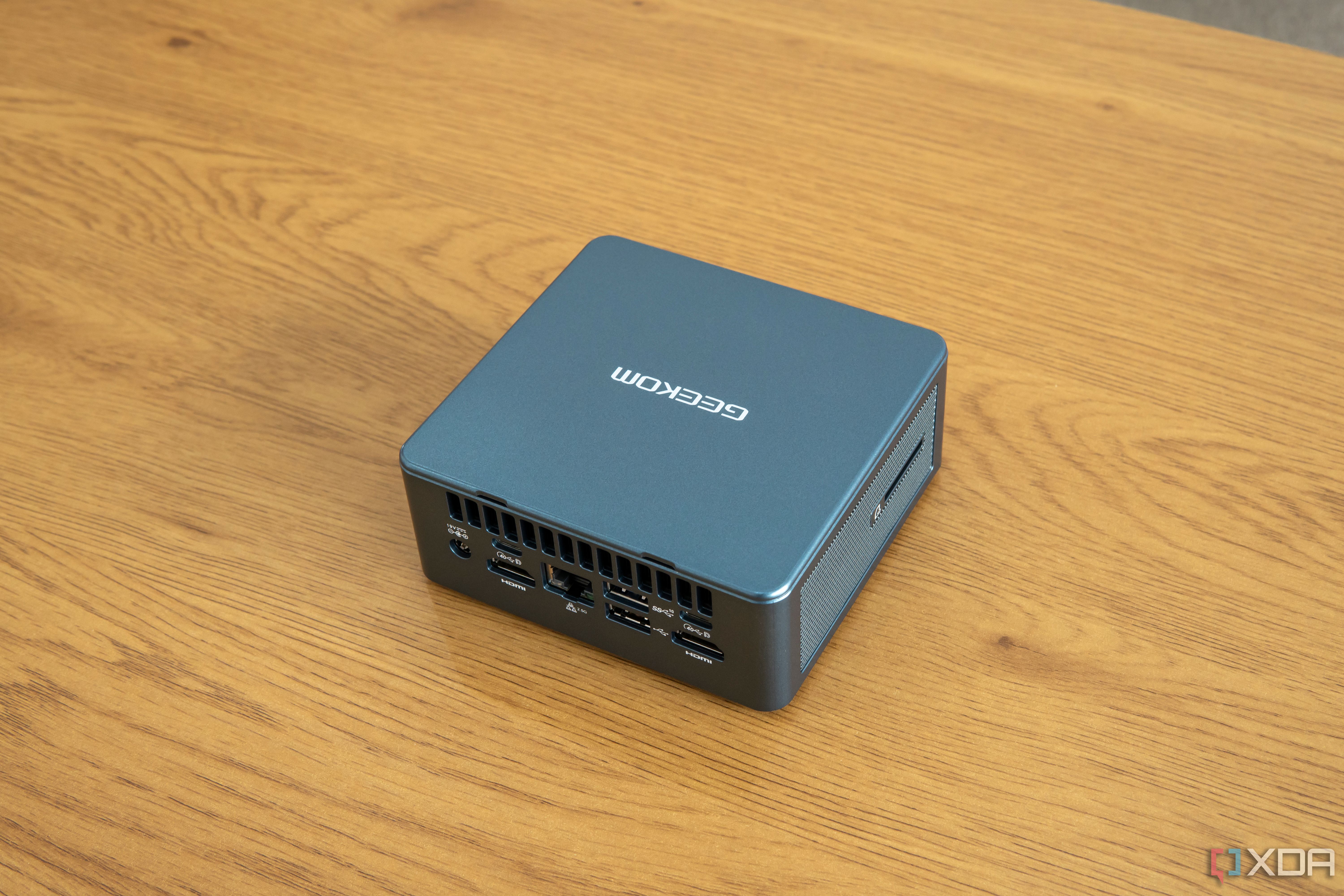 Angled rear view Geekom Mini IT13 mini PC on a wooden table