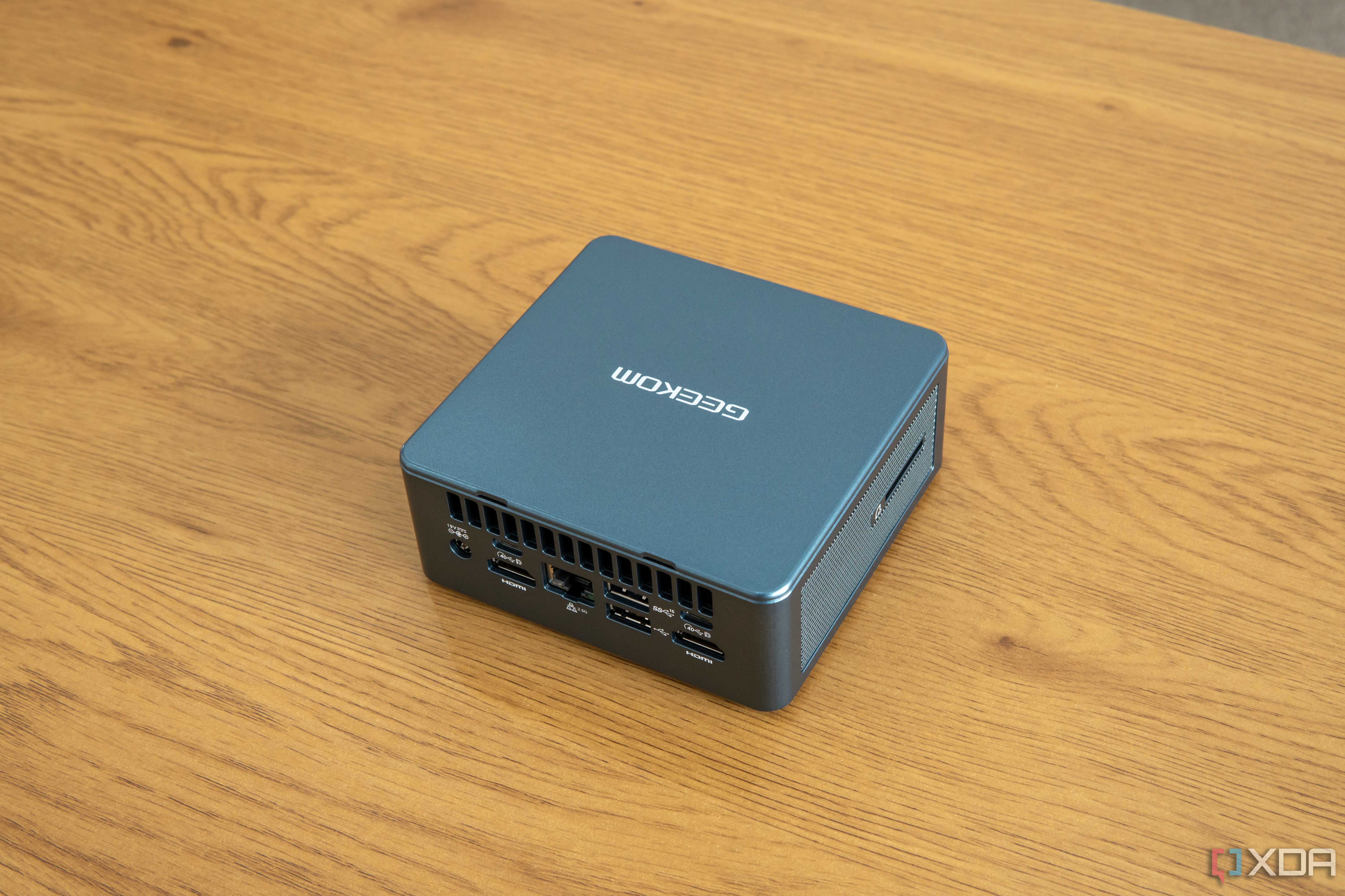Angled rear view Geekom Mini IT13 mini PC on a wooden table