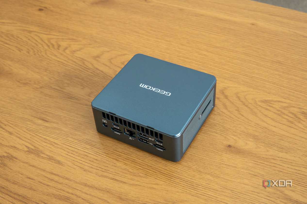 Angled rear view Geekom Mini IT13 mini PC on a wooden table
