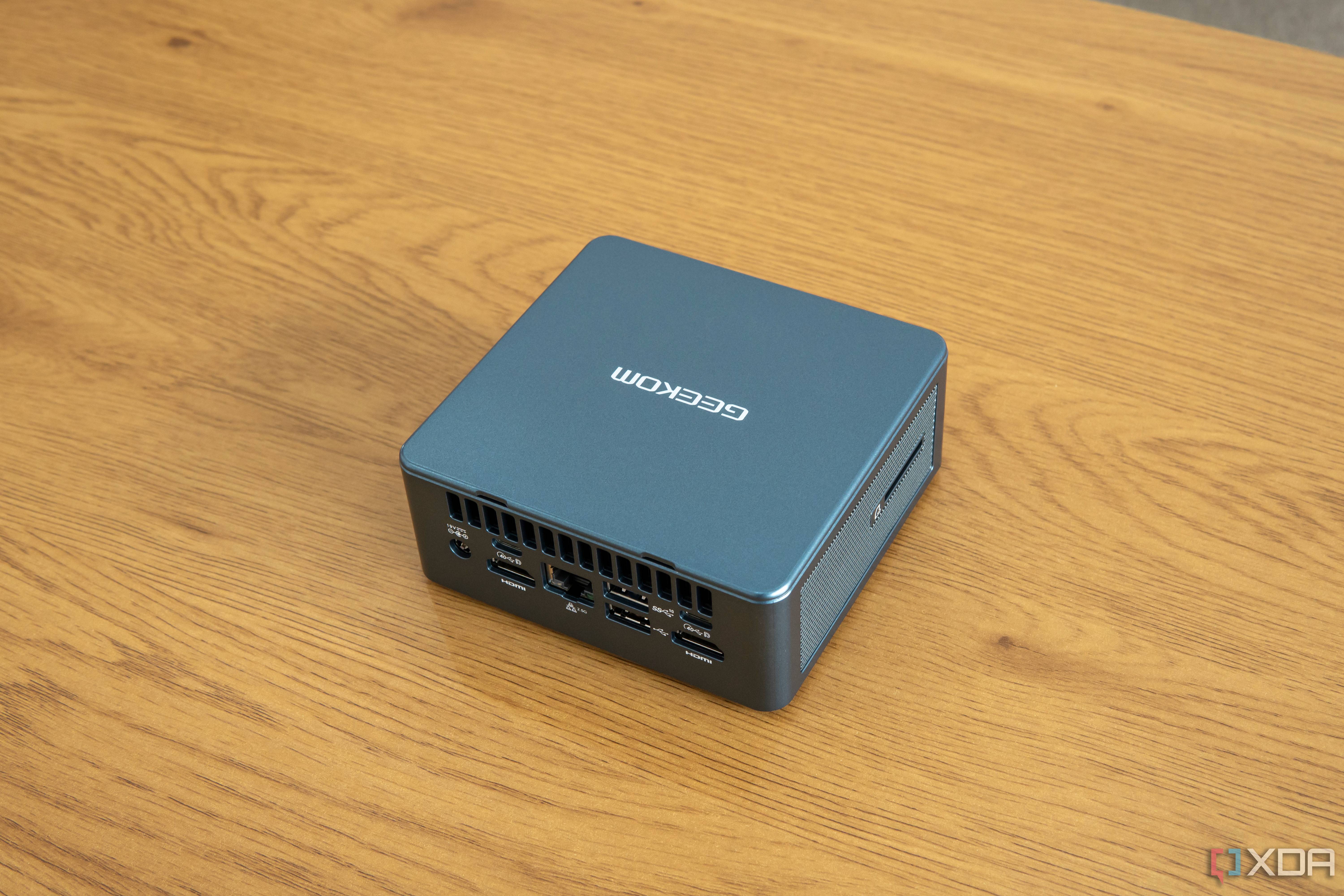 Angled rear view Geekom Mini IT13 mini PC on a wooden table