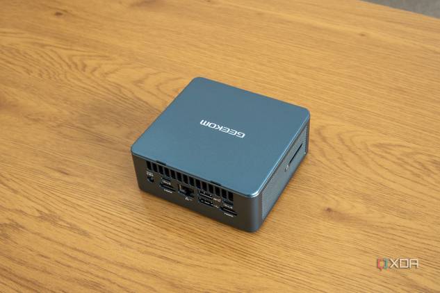 Angled rear view Geekom Mini IT13 mini PC on a wooden table