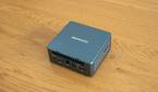 Angled rear view Geekom Mini IT13 mini PC on a wooden table