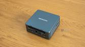 Angled rear view Geekom Mini IT13 mini PC on a wooden table