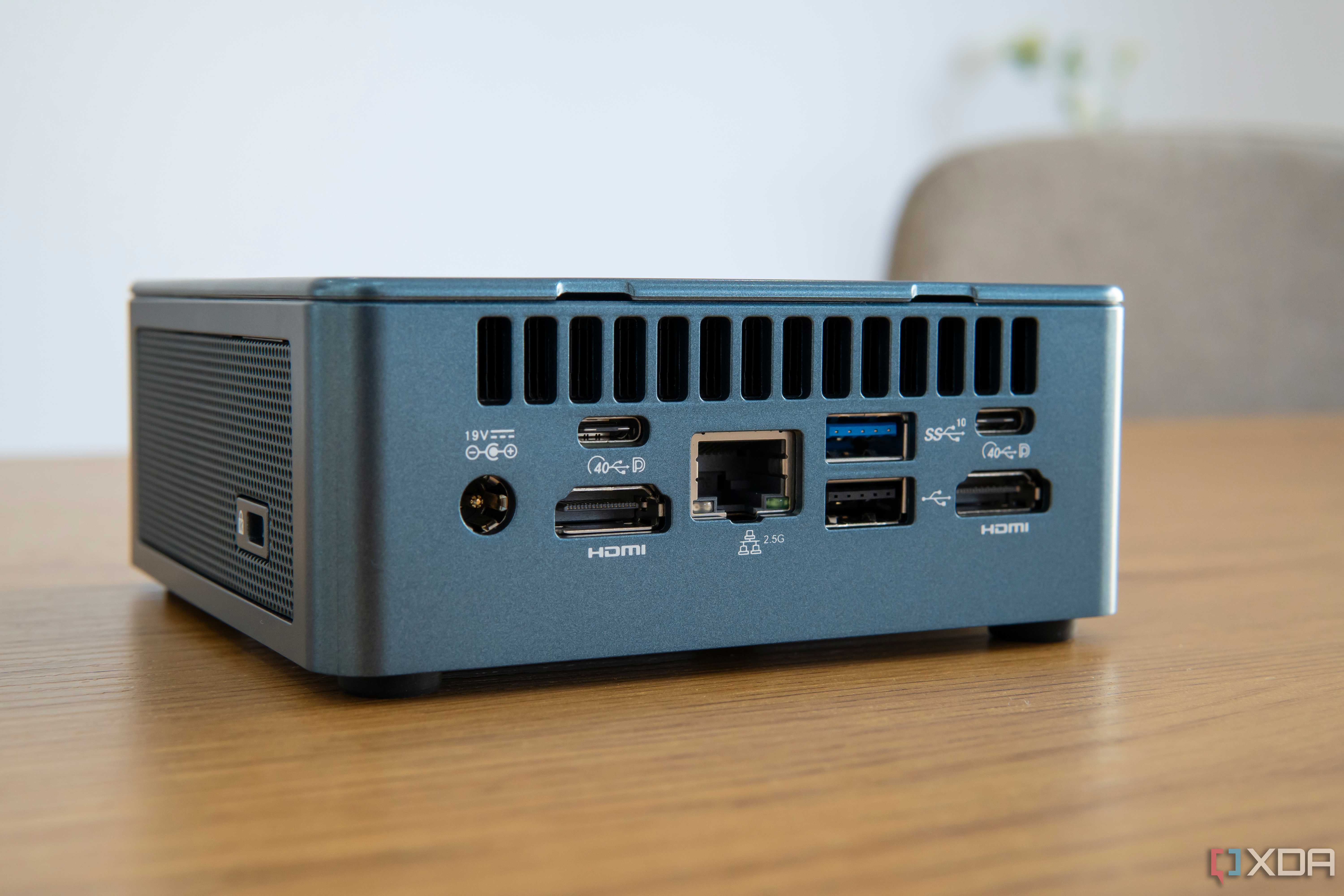 Angled rear view of the Geekom Mini IT13 on a wooden table