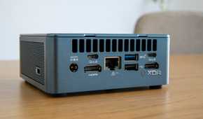 Angled rear view of the Geekom Mini IT13 on a wooden table