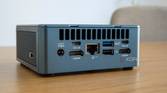 Angled rear view of the Geekom Mini IT13 on a wooden table