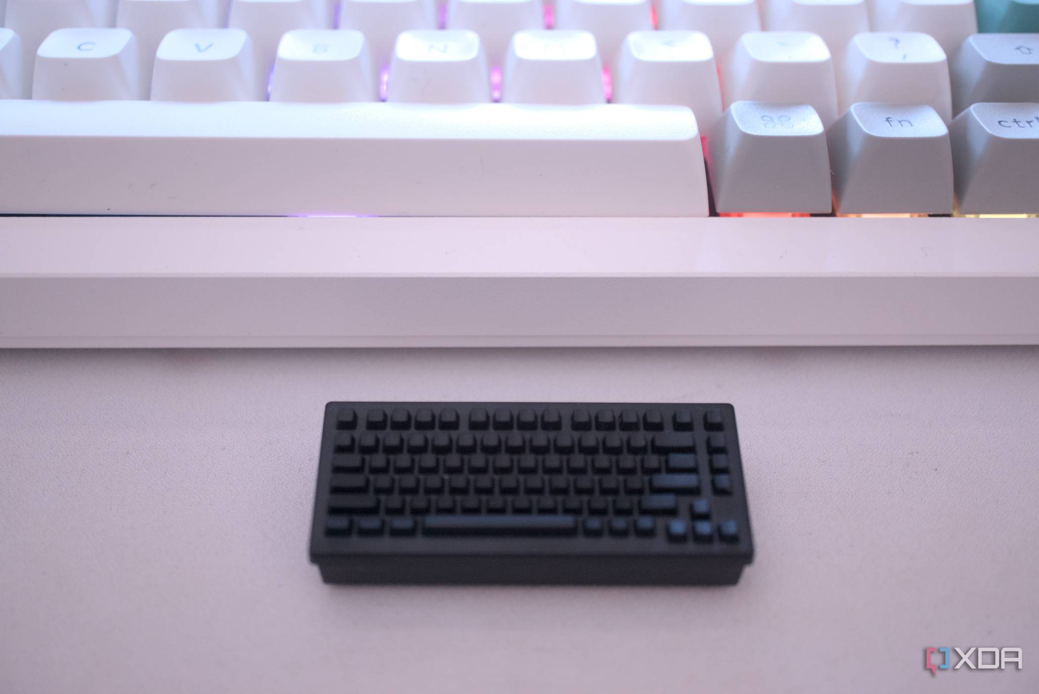 Keychron's wireless receiver in front of a keyboard