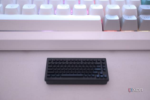Keychron's wireless receiver in front of a keyboard