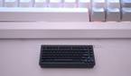 Keychron's wireless receiver in front of a keyboard