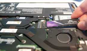 Slide the new SSD into the slot at a 20-degree angle