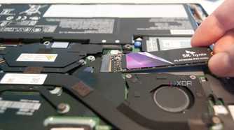 Slide the new SSD into the slot at a 20-degree angle