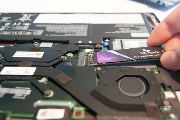 Slide the new SSD into the slot at a 20-degree angle