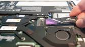 Slide the new SSD into the slot at a 20-degree angle
