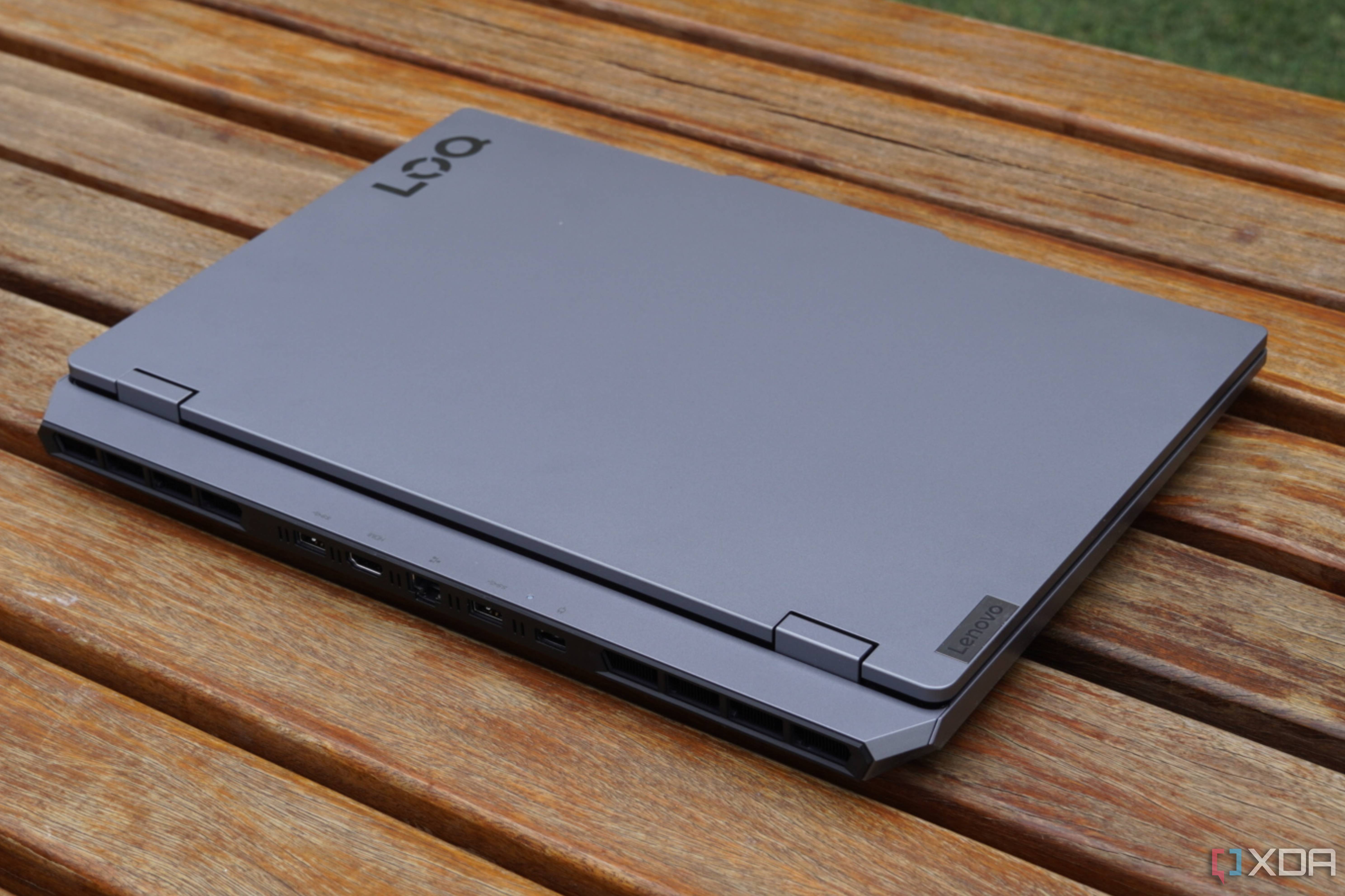 A closed Lenovo LOQ 15 on a picnic table.