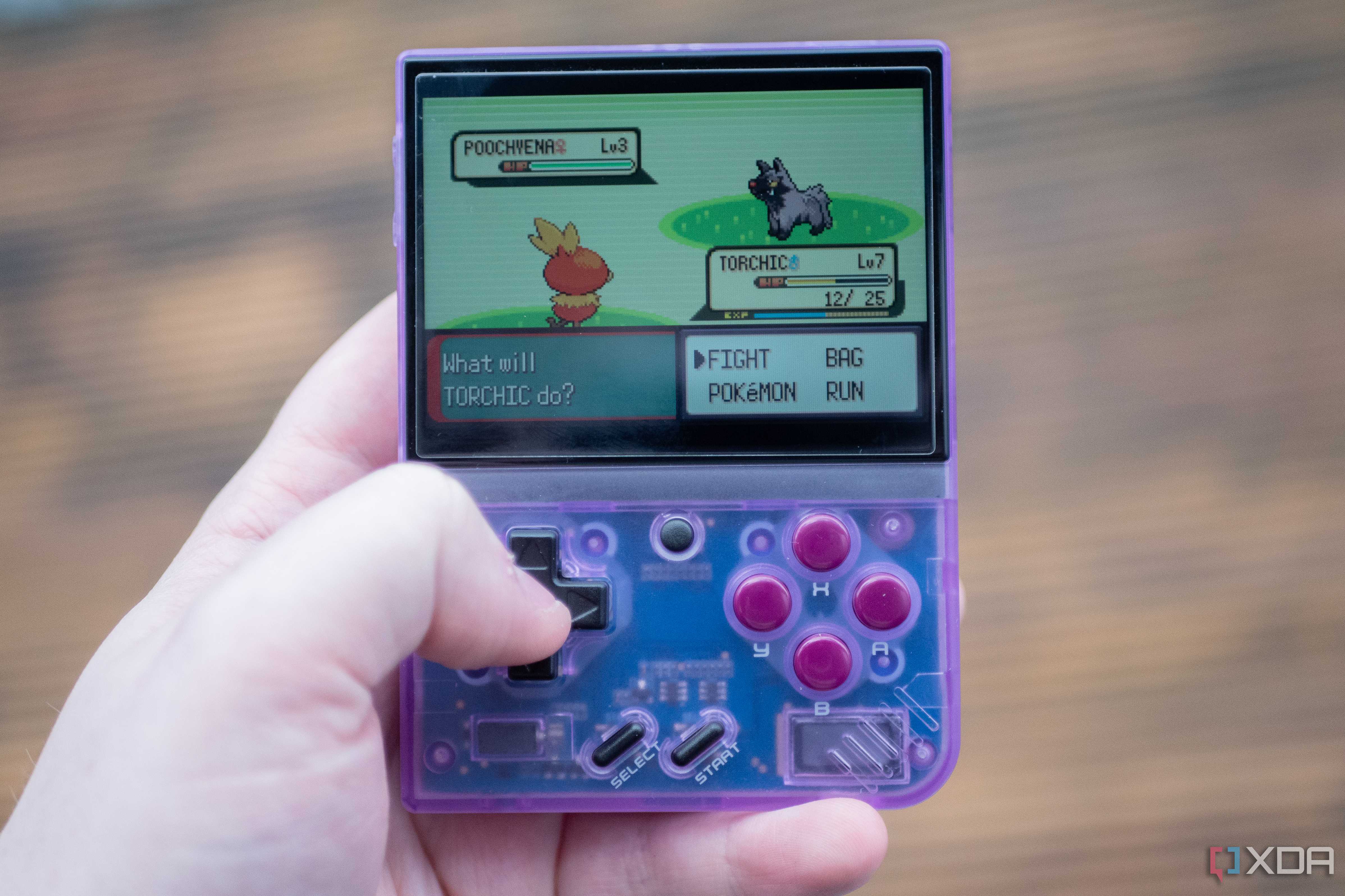 Miyoo Mini+ playing Pokemon Emerald in-hand
