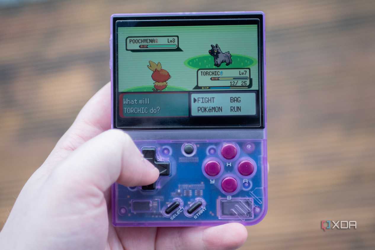 Miyoo Mini+ playing Pokemon Emerald in-hand