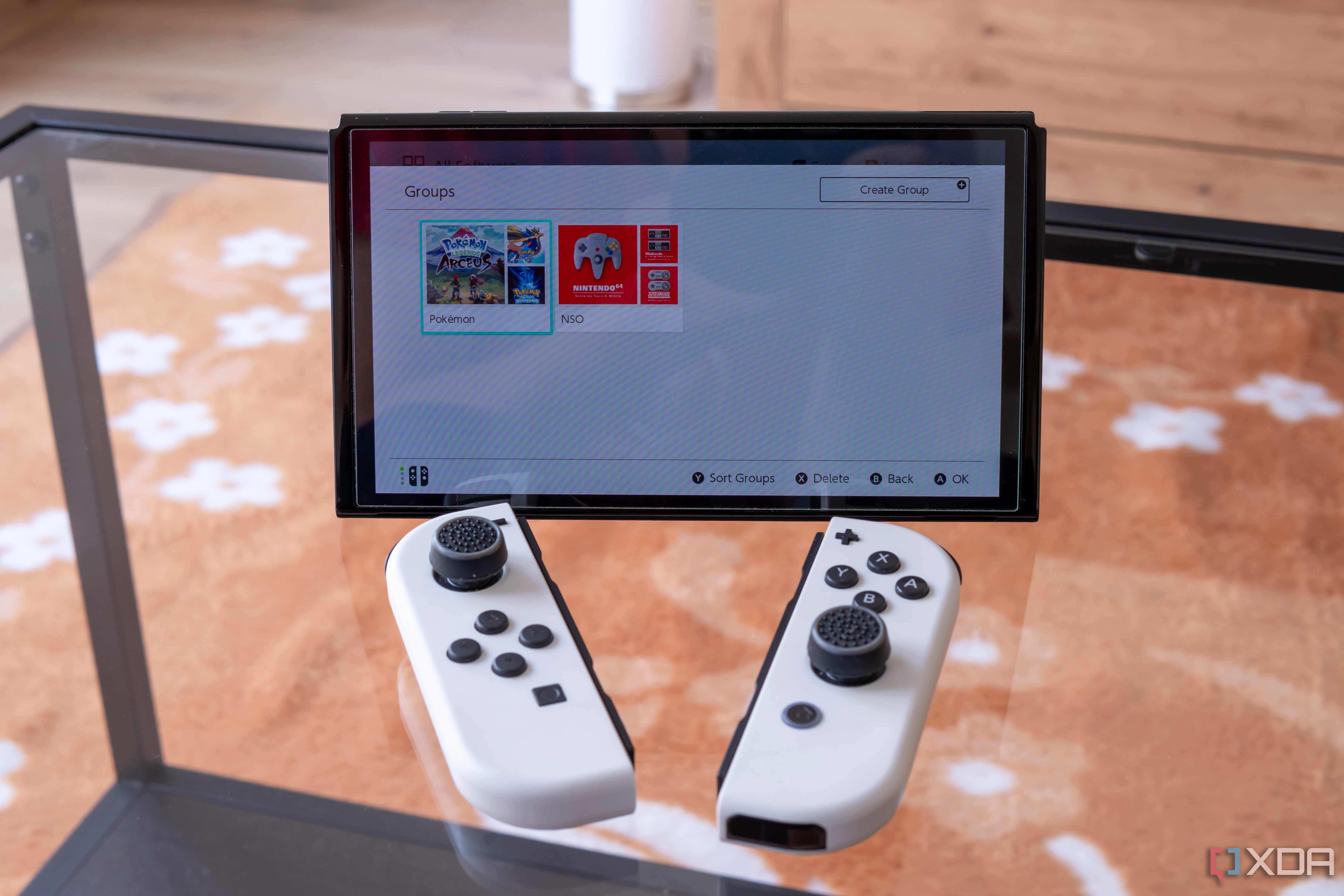A Nintendo Switch with the Joy-Con detached showing groups of apps