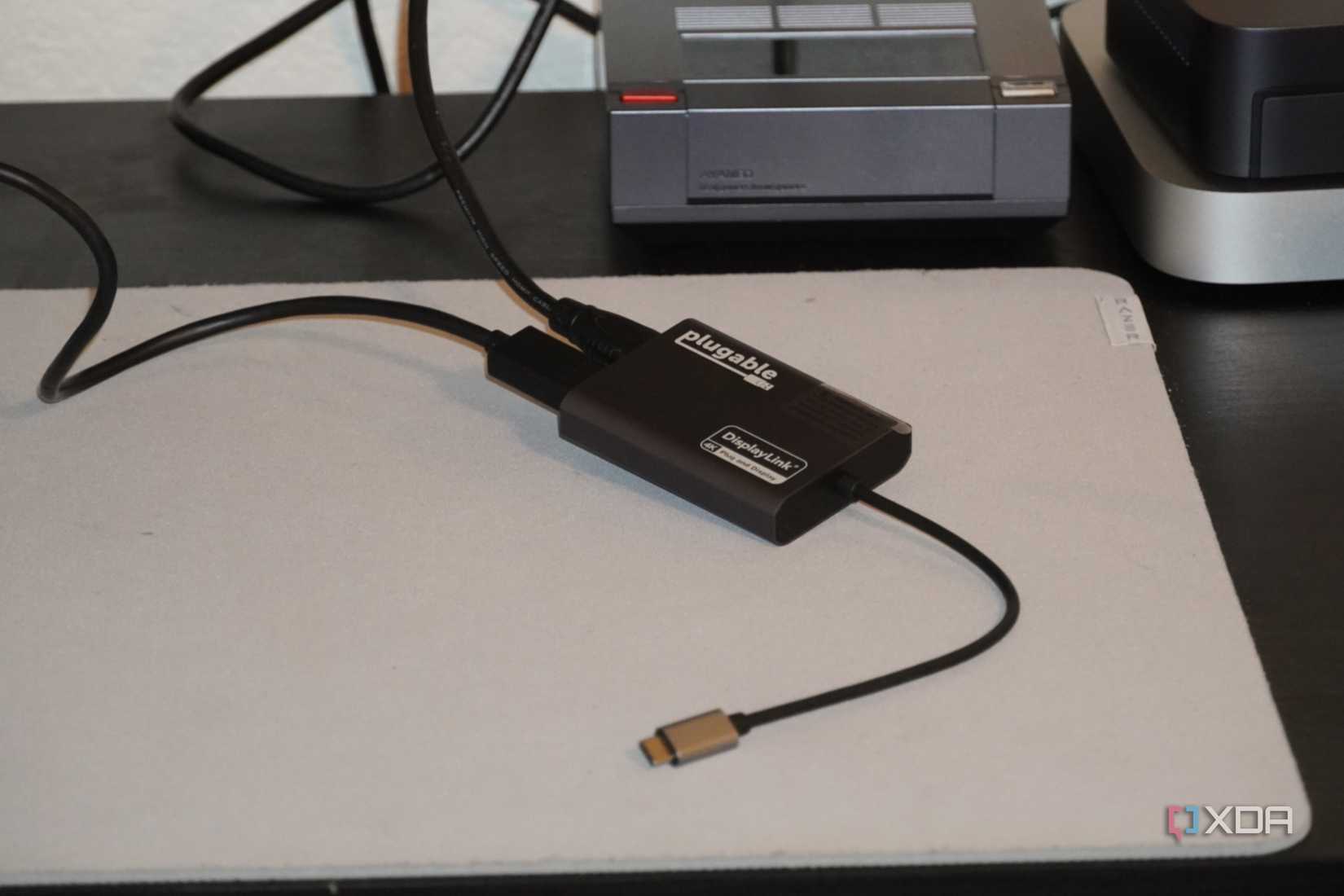 Pluggable dock and cables on the desk.