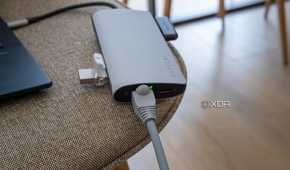 Satechi Multiport Adapter 8K with Ethernet V3 with an Ethernet cable and indicator light turned on