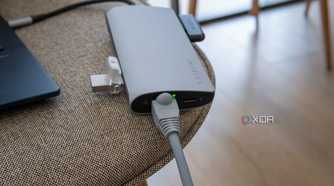 Satechi Multiport Adapter 8K with Ethernet V3 with an Ethernet cable and indicator light turned on