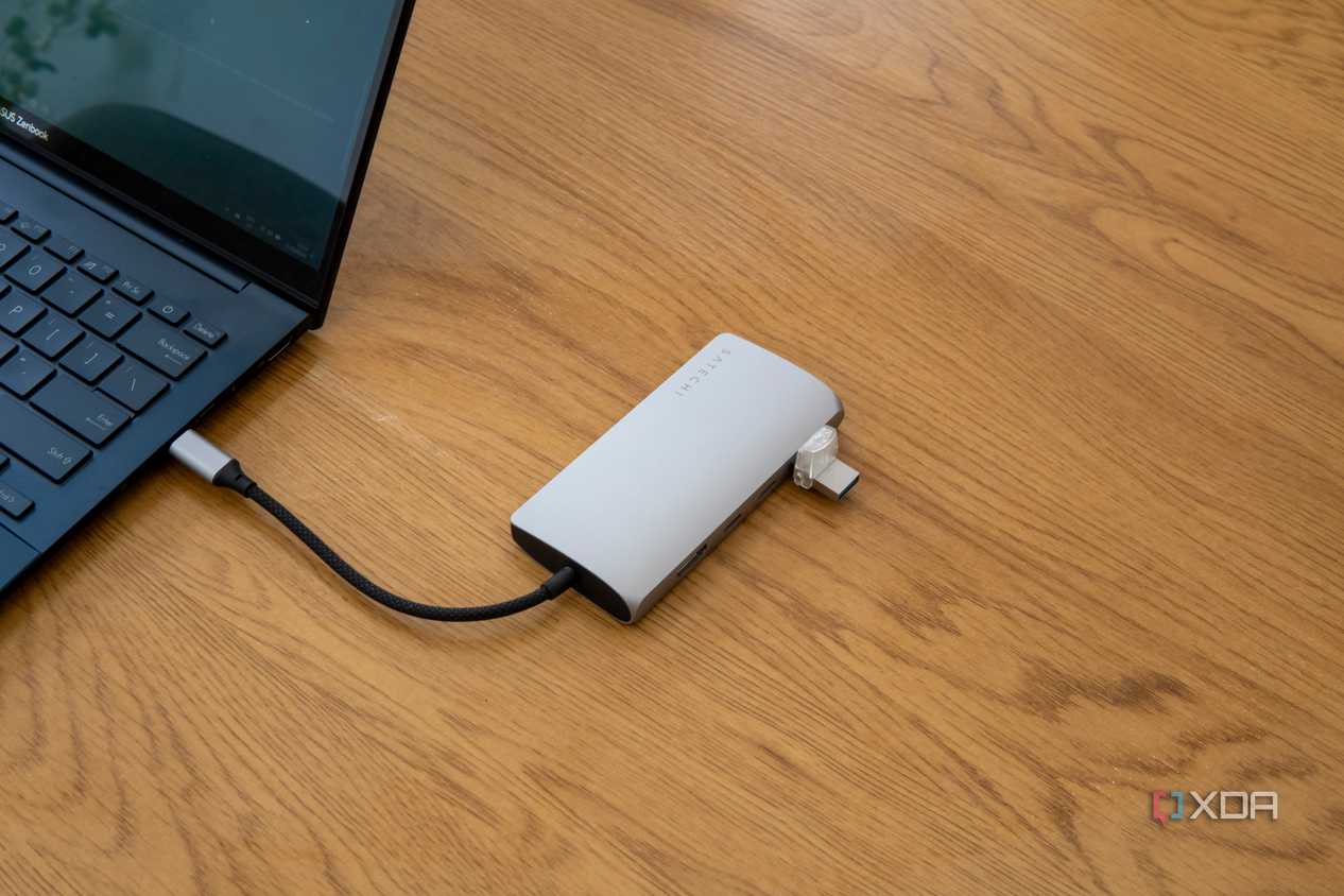 A Satechi Multiport Adapter 8K with Ethernet V3 connected to a laptop with a USB drive plugged in