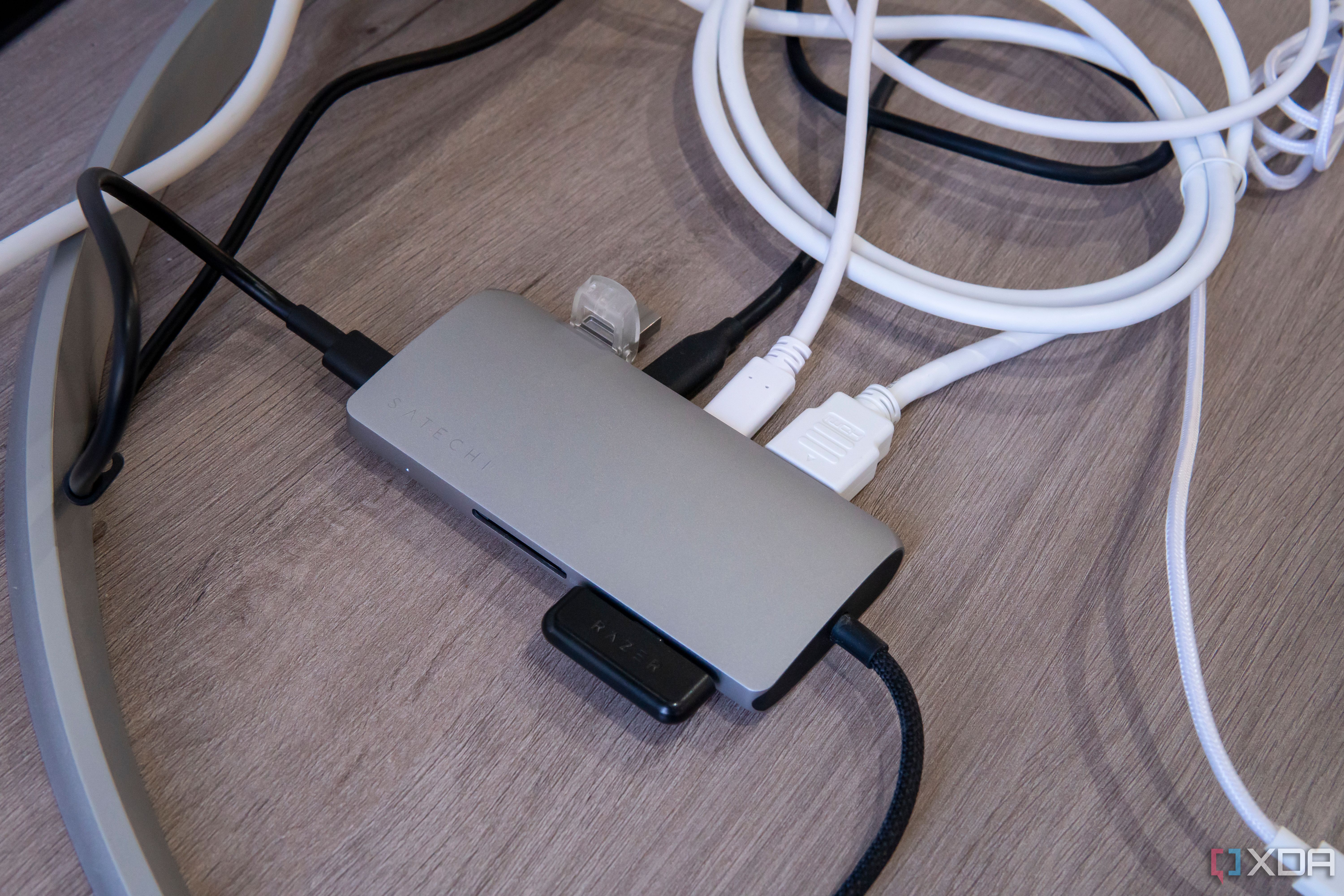 Satechi Multiport Adapter 8K with Ethernet V3 with a display and multiple peripherals connected