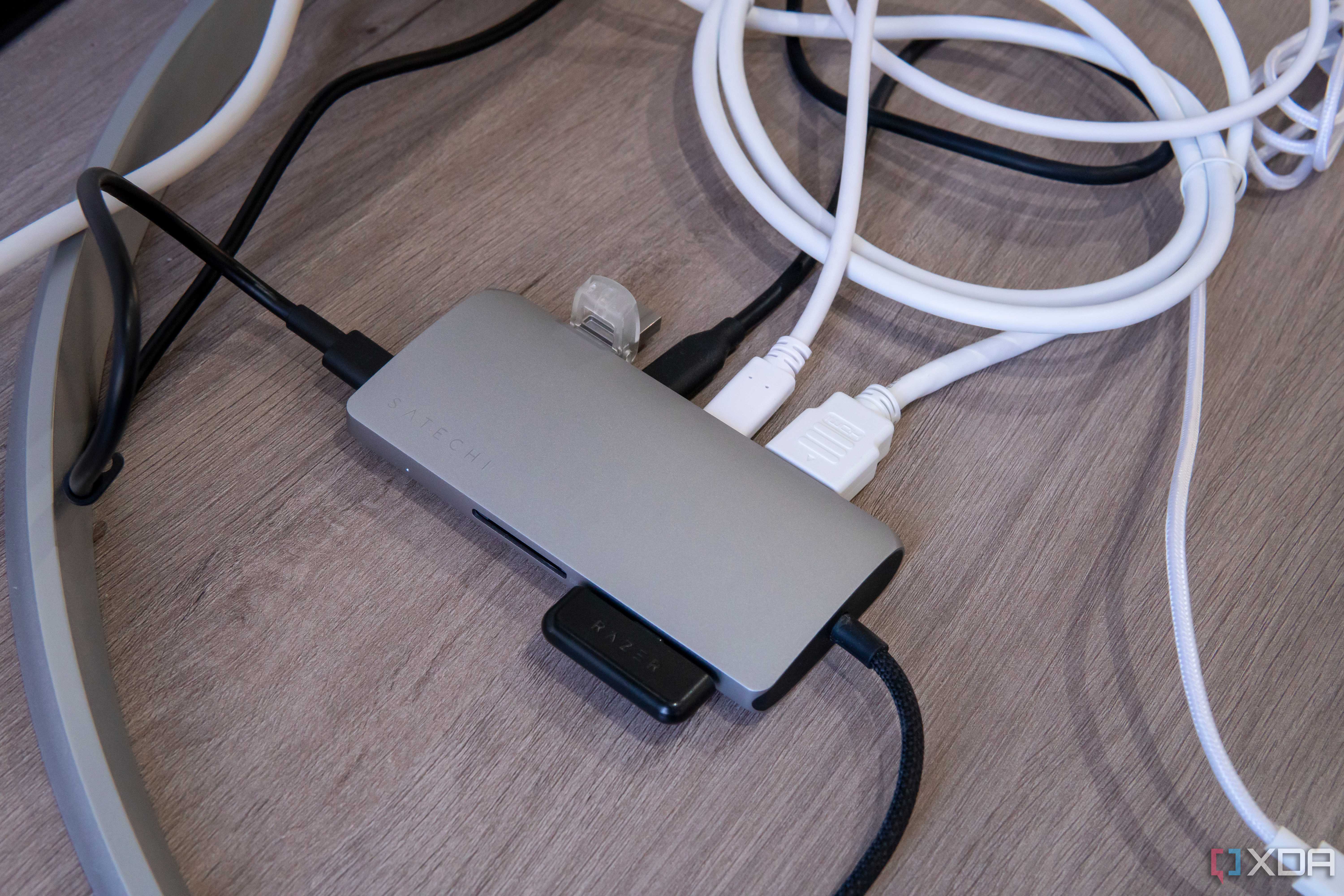 Satechi Multiport Adapter 8K with Ethernet V3 with a display and multiple peripherals connected